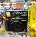 Nikon Coolpix A900 compact camera 20.3 effective megapixels CMOS image sensor and 35x optical zoom, displaying on a shelf.